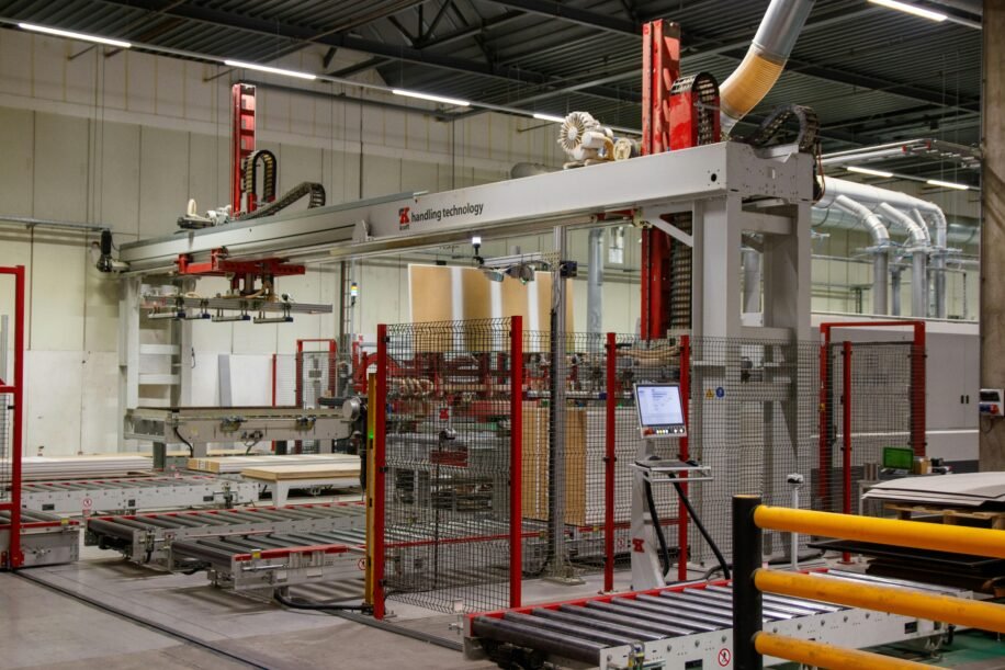 Industrial machinery with robotic arm in a modern manufacturing facility.